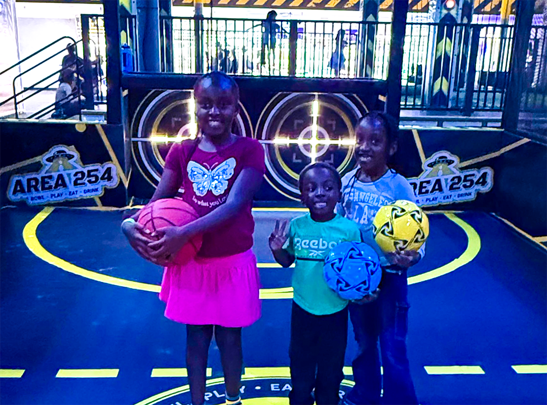 kids smiling with basketballs