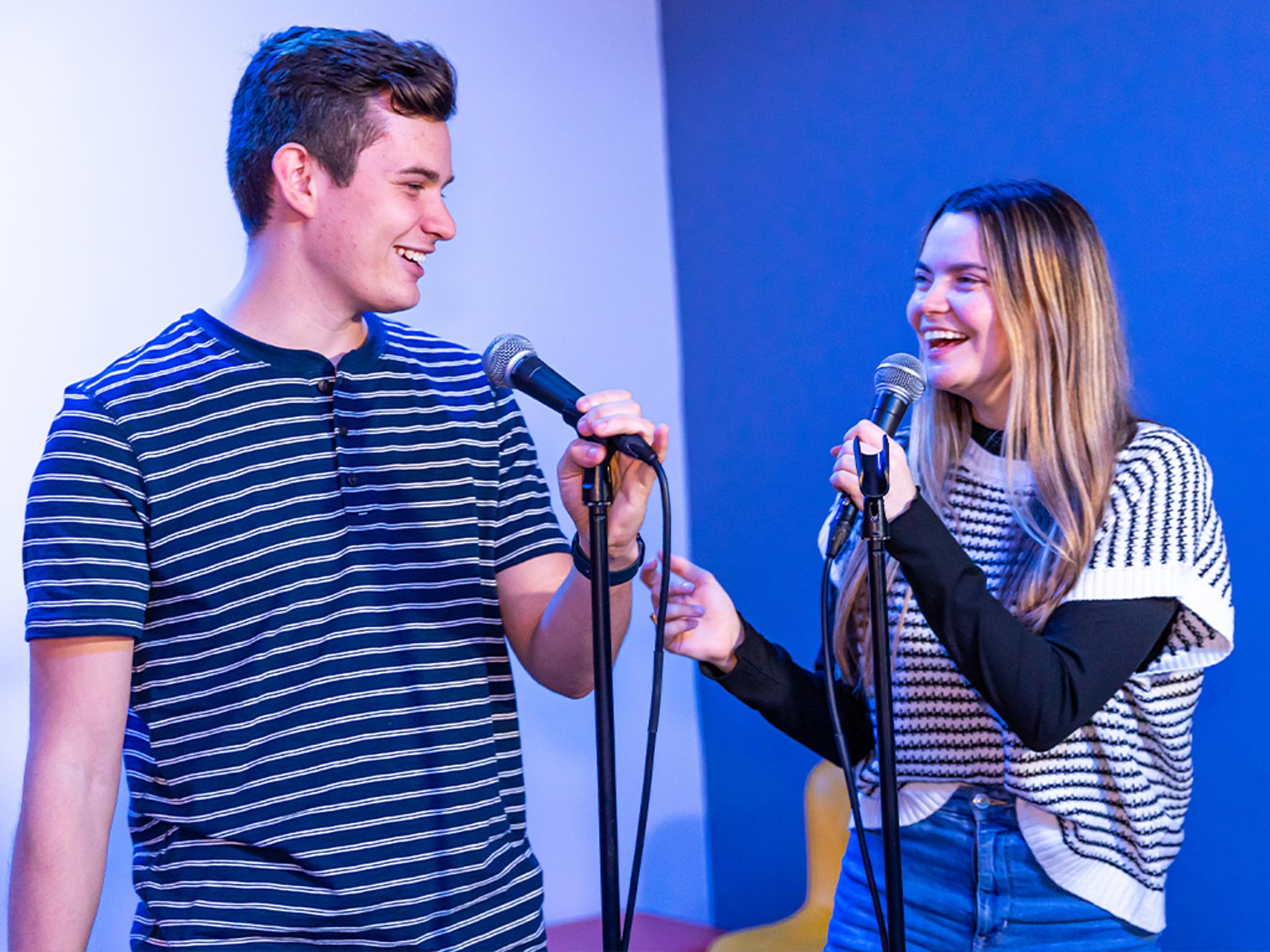 two young adults singing