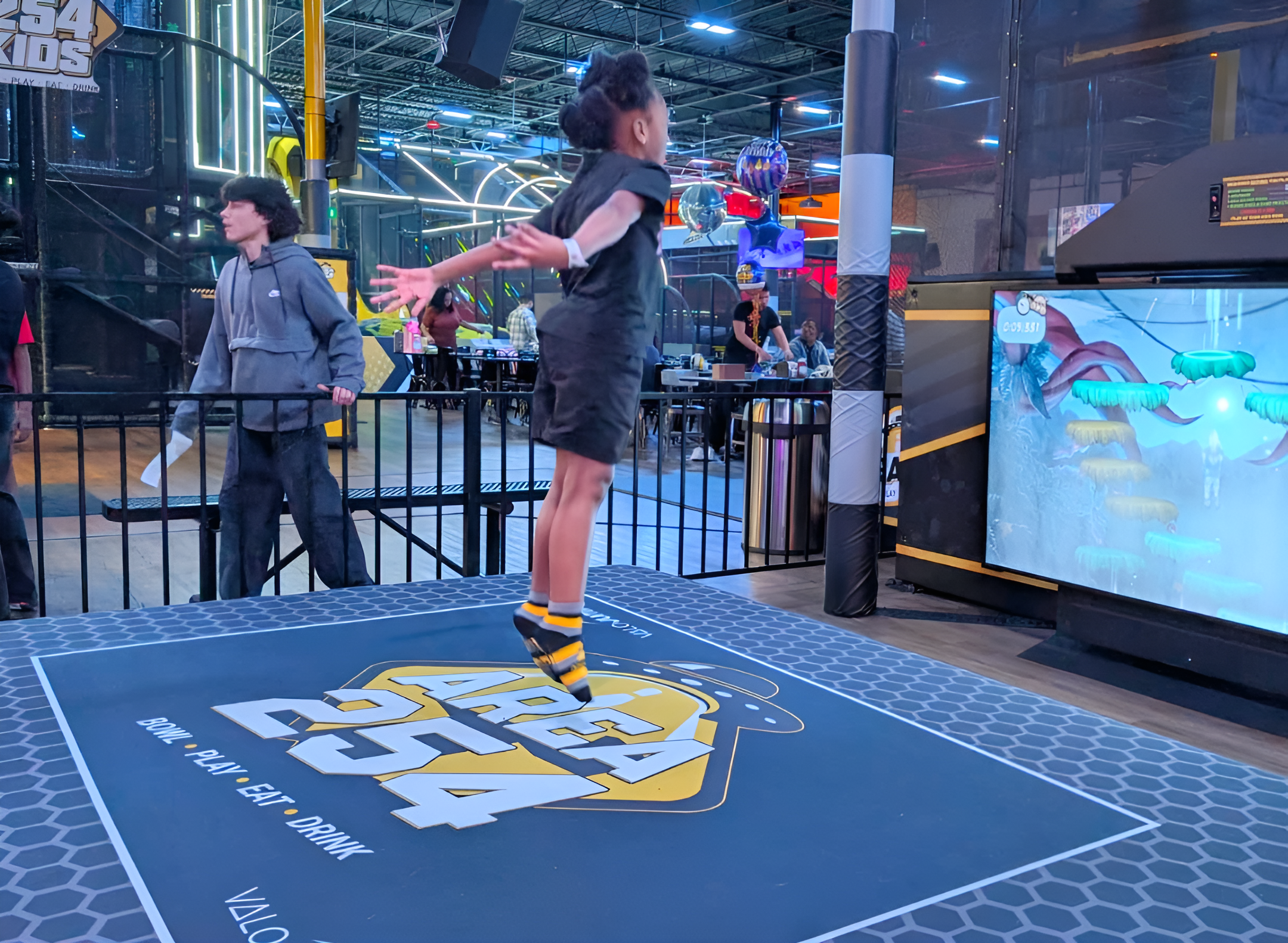 young boy on jumping pad with screen